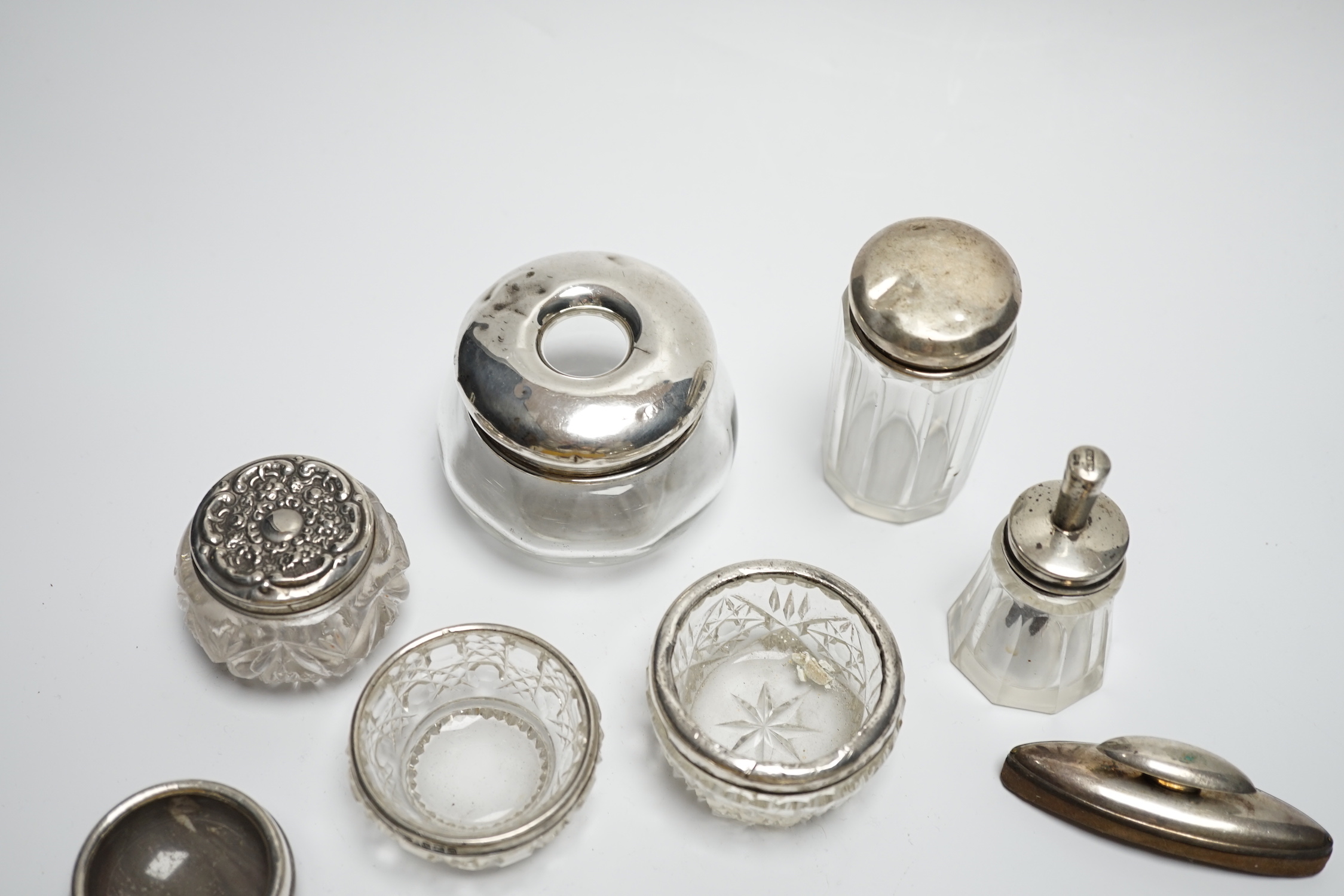 Eight assorted silver topped toilet jars, a silver mounted nail buffer and pen wipe.